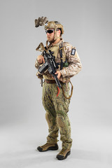 Special forces soldier with rifle on white background.
