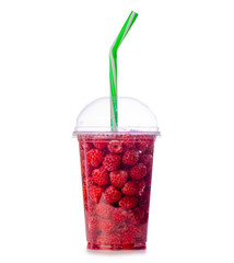 Raspberries in a glass of lemonade on a white background isolation
