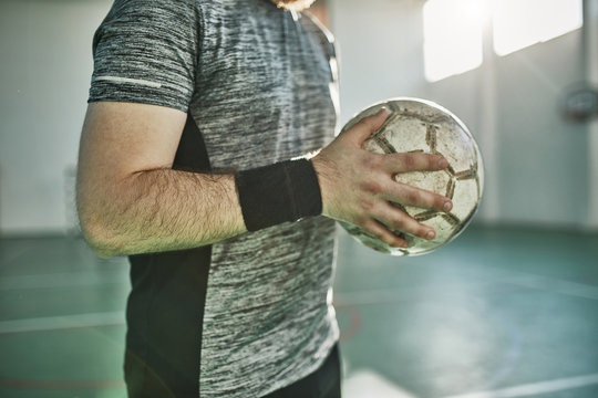 Close-up of indoor soccer player holding the ball