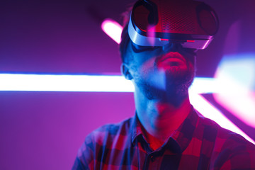 Bearded man in VR against glowing neon