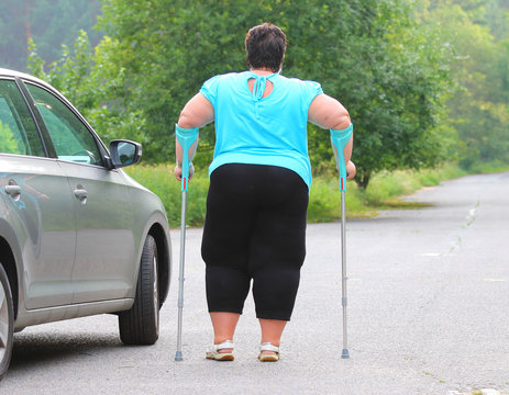 Disabled woman upgoing from a car. Transportation and travel for handicapped people.