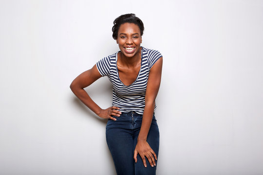 beautiful black woman standing and laughing leaning forward