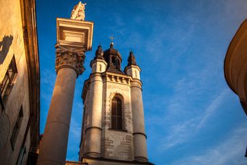 Armenian Cathedral of Lviv with St. Christopher column on blue sky background