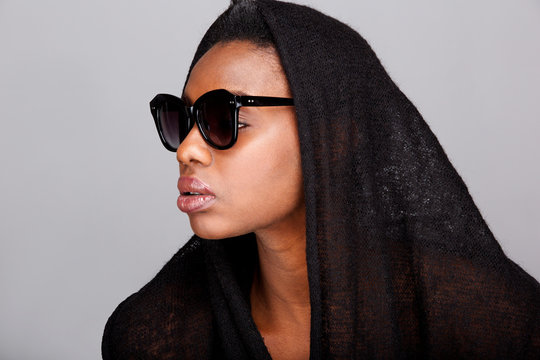 Side Portrait Of Beautiful African American Woman With Headscarf And Sunglasses
