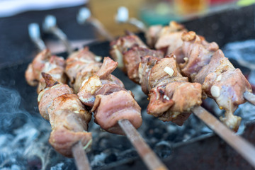 Meat grilling on charcoal and flame