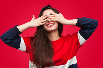 Charming brunette covering eyes in surprise