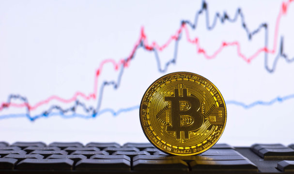 Bitcoin. Golden Bitcoin on the background of the chart. Trading concept. Stock market graph.
