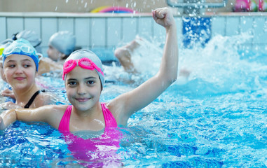 Happy children kids group at swimming pool class learning to swim © blicsejo