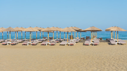 Fototapeta na wymiar straw parasols on the beach of Falassarna, Crete