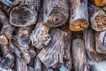 stack of firewood stacked for a stove and a fireplace near the house in rustic rustic style background with space for text