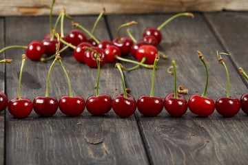 Cherry ripe, fresh on a wooden table. Cherry red ripe. Fresh cherry on a wooden table.