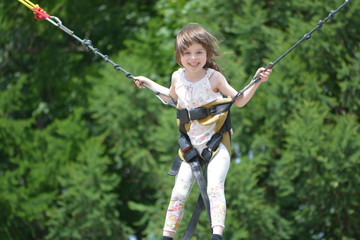 Girl jumping at a trampoline