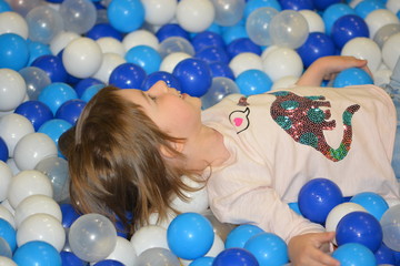 Little girl in a soft balls pool