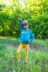 Obraz premium Toddler girl dancing in the park.