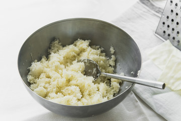 Cooking cabbage salad: cabbage with mayonnaise and salt in a metal bowl