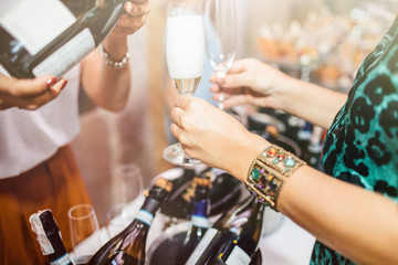 Young people are drinking sparkling wine on corporate event.