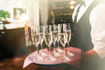 Pouring champagne into a glass on a wedding celebration