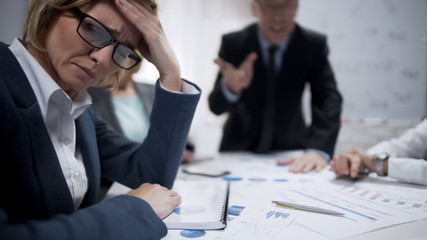 Woman consultant feeling stress at meeting, occupational burnout, overworked