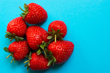 Delicious strawberries on blue background
