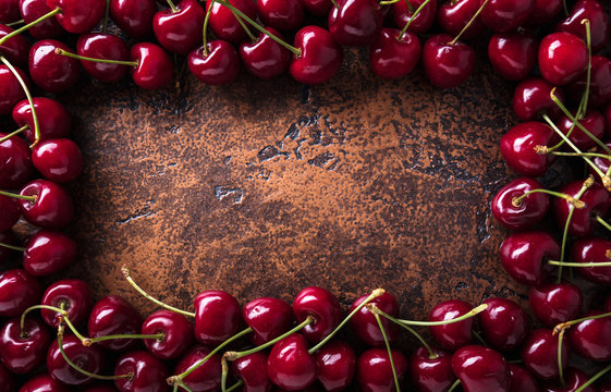 Sweet organic cherries on old copper table.