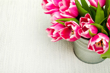 Pink tulip bouquet on light background, copy space