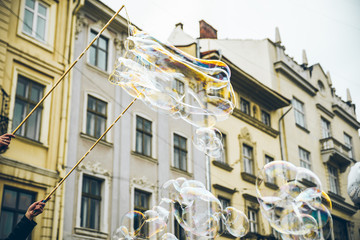soap bubbles in the center of old european city. having fun