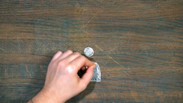 Closeup of hand draws on a wooden board. Human figure in the center. question