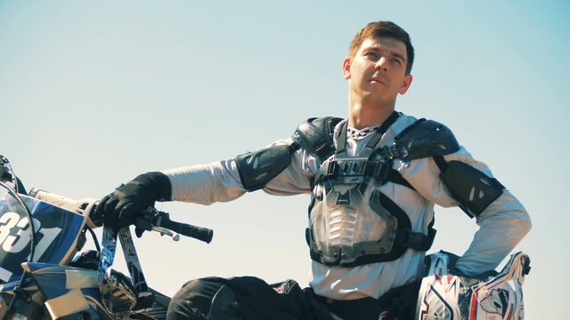 Male cycler is sitting on his autobike