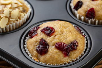 Homemade muffins with cherry in a baking form