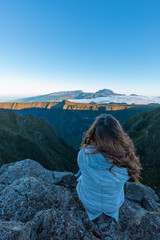 Naklejka premium Girl watching the Piton des Neiges from the Riviere des Remparts in Reunion Island