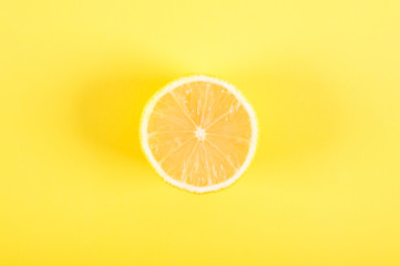 Half of lemon on a yellow background