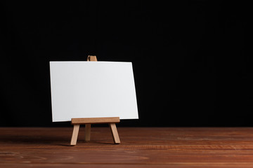 A small easel, a layout, a blank, white on a black background.