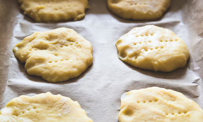 Fototapeta na wymiar Home handmade baking, the dough on parchment paper for baking