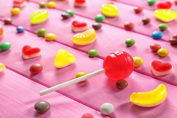 Colorful candies on wooden background