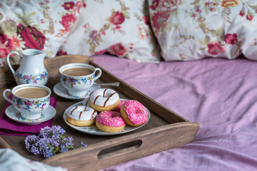 Breakfast in bed with coffee and donuts