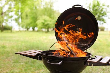 Modern barbecue grill with fire flames outdoors