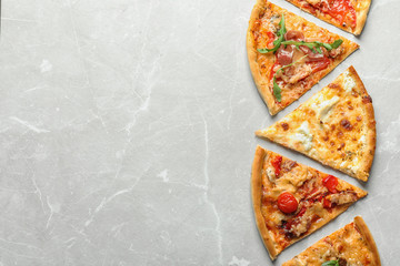 Slices of delicious pizza on light background, top view