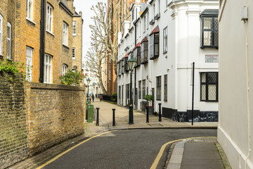 Empty street in Kensington and Chelsea London United Kingdom with houses cars and bikes