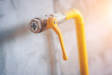 Close up of a yellow gas pipe in the house