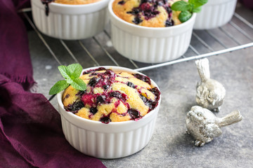 Small berry pies in a ceramic baking dish.