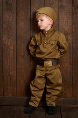 children are dressed as soldier in retro military uniforms