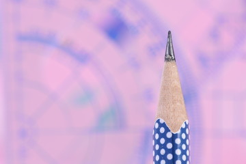 Pencil with geometry set in background, back to school