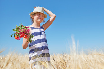 child girl walking in the yellow wheat field, bright sun, summer landscape