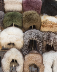 Natural fur hats. Handmade wool fur headdress shop bazaar in Bukhara, Uzbekistan. Selling group of different winter fur hats for women and men.