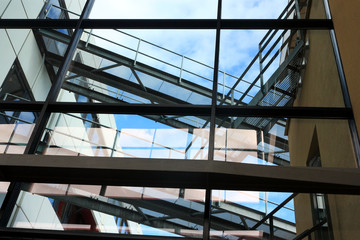 Modern architectural elements with reflections and blue sky