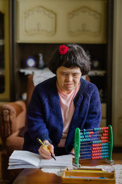 Female with down's syndrome having educational time at her home