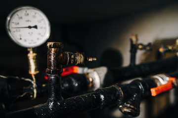 Heating system's cooper pipes with ball valves on a grey wall