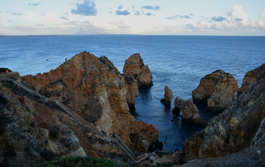 Fototapeta na wymiar Amazing and unique cliffs formation with sea arches, grottos and smugglers caves in Lagos, Algarve, Portugal