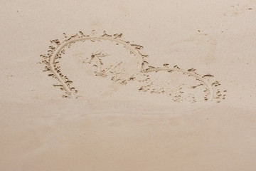 Heart and Caribbean Sea inscription on the sand