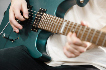 Fototapeta premium Close up of man playing on electric guitar